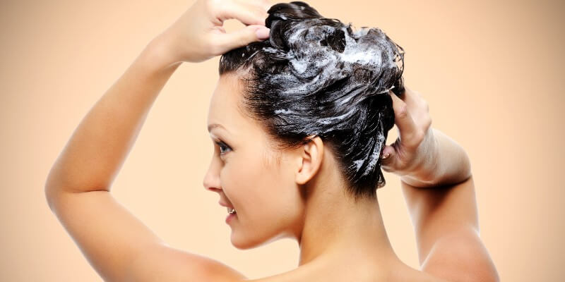 woman shampooing her hair