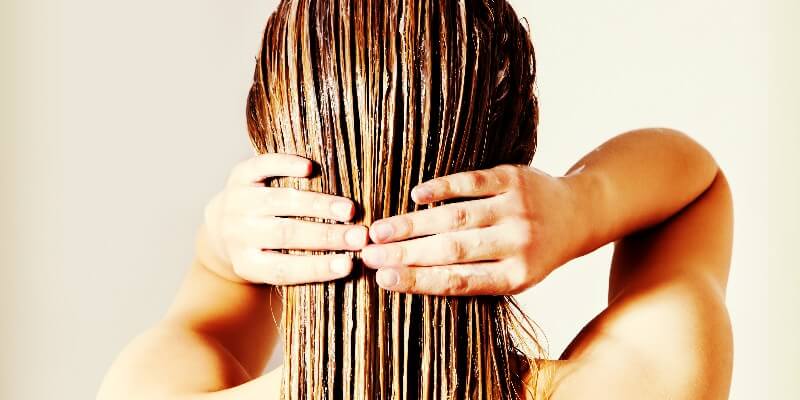 woman conditioning her hair