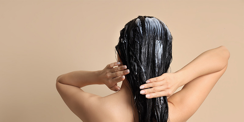 lady rubbing her hair with product